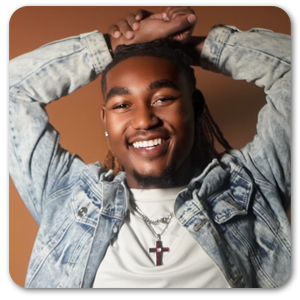 Picture of King smiling in a relaxed pose on a warm background